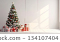 Peaceful view of a tree and gifts decorating a white room 134107404