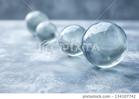 Glass spheres on frosty surface with soft winter light 134107742