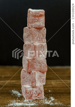 Pyramid of pink rahat lokum cubes with rose petals flavor. Pyramid of pink rahat lokum cubes with rose petals flavor. 134108024