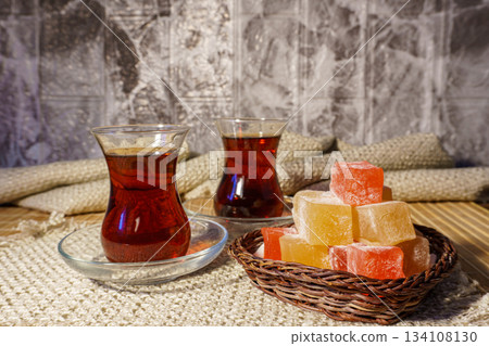 Rahat lokum against the background of two glasses of turkish tea Rahat lokum against the background of two glasses of turkish tea 134108130