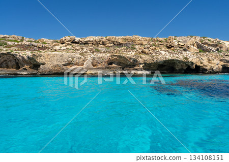 Favignana, Sicily, Italy. Rocky coastline with caves and turquoise water Favignana, Sicily, Italy. Rocky coastline with caves and turquoise water 134108151