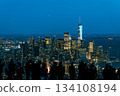 Tourists admire the New York City skyline at dusk from an observation deck 134108194