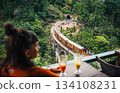 Woman watches train cross Nine Arch Bridge Sri Lanka from a cafe 134108231