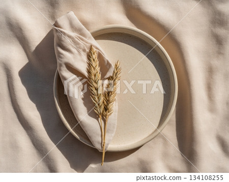 Minimal table setting with plate and dry stem 134108255
