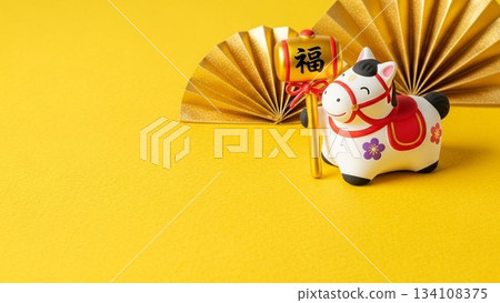 New Year's zodiac ornaments and folding fans on a yellow background New Year's zodiac ornaments and folding fans on a yellow background 134108375