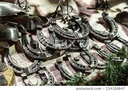 Handmade metal products from a blacksmith are on display at the New Year fair on Red Square near GUM. Horseshoes 134108647