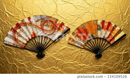 Two beautiful folding fans spread out on golden Japanese paper 134109526
