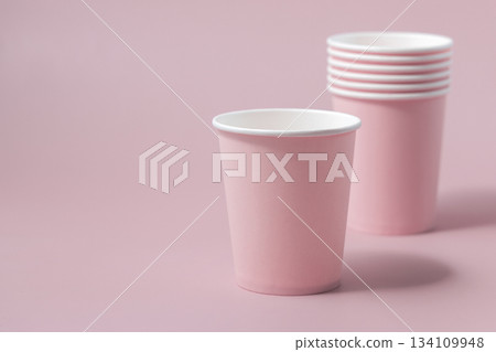 Disposable light pink paper cups closeup, mockup, copy space. No plastic biodegradable single-use 134109948