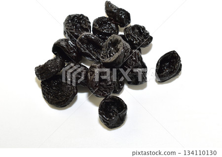 A pile of dried plums, prunes. 134110130