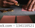 Hand placing bitcoin token on playing cards table 134110521