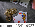 Playing cards and bitcoin cryptocurrency tokens on table 134110527