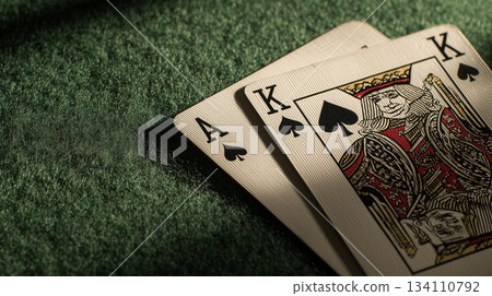 Ace and king of spades on green poker table 134110792