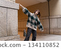 A woman leaning on the wall 134110852