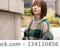 A woman leaning on the wall 134110856