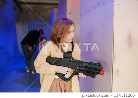 Kids engage in an exciting laser tag game indoors 134111260