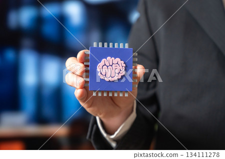 A microchip with neural network technology in the hands of a businessman. Innovative technologies in microelectronics. AI hardware evolution. Tech sector news, R&D and corporate innovation 134111278