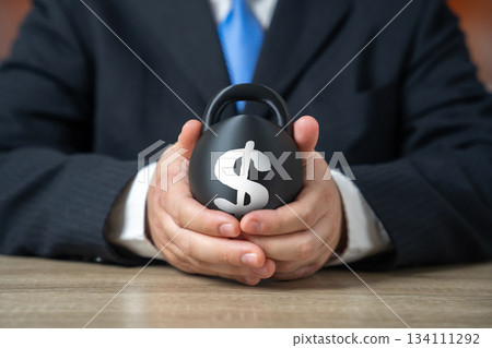 A heavy burden of debt in the hands of a businessman. Rising interest costs create risks. Weight of obligations slows development. Heavy burden of debt in the hands of a businessman. A heavy burden of debt in the hands of a businessman. Rising interest costs create risks. Weight of obligations slows development. Heavy burden of debt in the hands of a businessman. 134111292