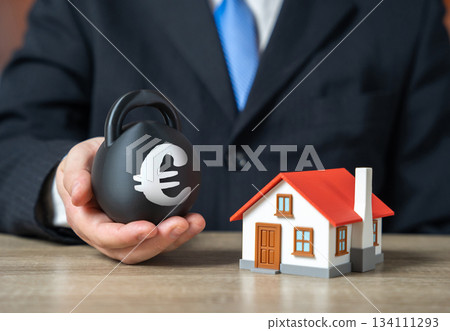Home mortgage debt. Euro symbol on a weight. Hard-to-afford down payment for a mortgage. Tough loan terms, expensive down payments and unstable market conditions. Home mortgage debt. Home mortgage debt. Euro symbol on a weight. Hard-to-afford down payment for a mortgage. Tough loan terms, expensive down payments and unstable market conditions. Home mortgage debt. 134111293