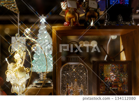 Christmas trees, lights, and Santa Claus figurines sold at a Christmas market 134112080