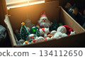 Vintage Christmas toys rest inside a simple cardboard box. Nostalgia and the charm of old holiday traditions. 134112650