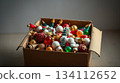 Vintage Christmas toys rest inside a simple cardboard box. Nostalgia and the charm of old holiday traditions. 134112652