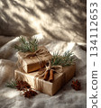 Rustic cozy gift setup features cinnamon sticks and pine accents. Simplicity, seasonal comfort, and handmade detail. 134112653