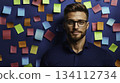 Young man with glasses posing in front of colorful sticky notes background 134112734