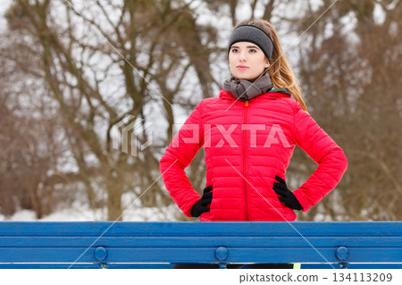 Woman wearing sportswear exercising during winter Woman wearing sportswear exercising during winter 134113209