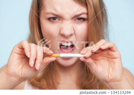 Addiction. Girl breaking cigarette. Quit smoking. Addiction. Girl breaking cigarette. Quit smoking. 134113294