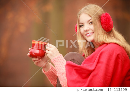 Girl with cup in park. 134113299