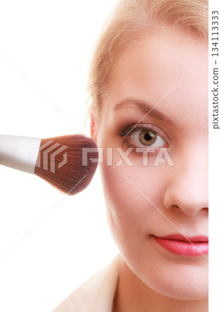 Part of woman face applying rouge blusher makeup detail. 134113333