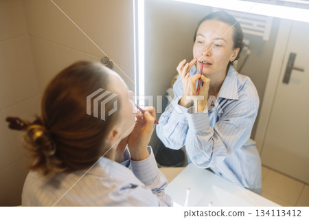Calm mom completes makeup routine amid busy household tasks Calm mom completes makeup routine amid busy household tasks 134113412