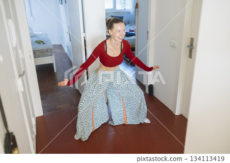 Caucasian woman lifts herself in tight hallway environment Caucasian woman lifts herself in tight hallway environment 134113419