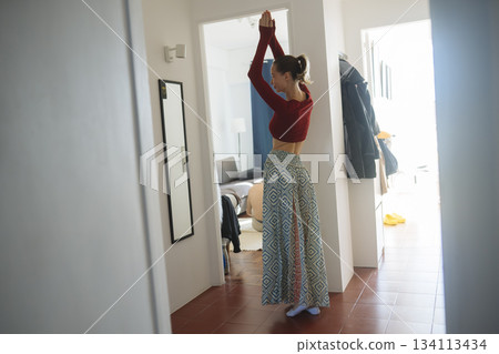 Caucasian woman expressing joy through dance in sunlight 134113434