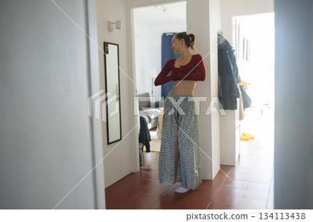 Woman quietly performing focused physical activity within personal space Woman quietly performing focused physical activity within personal space 134113438