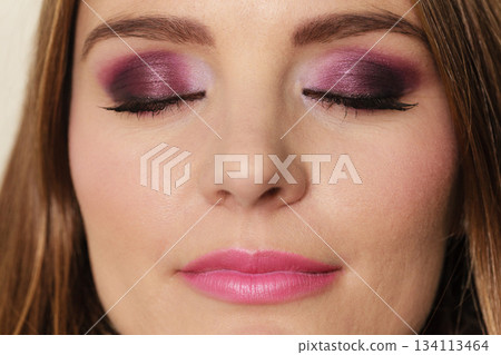 Woman closed eyes with violet dark shadows makeup 134113464