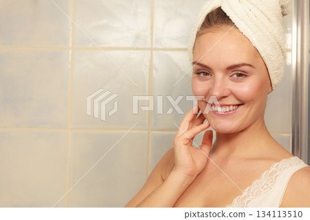 woman in towel on her head in bathroom 134113510