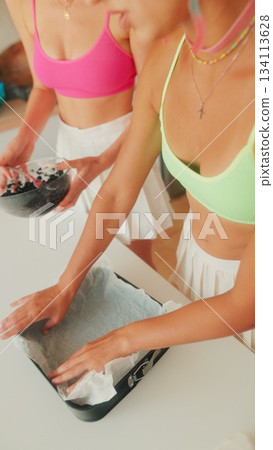 Engaging in Baking Preparations with Friends while Wearing Stylish and Colorful Outfits Engaging in Baking Preparations with Friends while Wearing Stylish and Colorful Outfits 134113628
