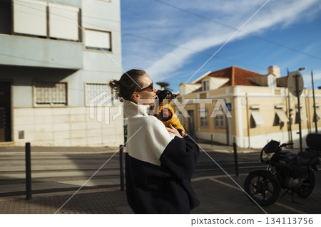 Energetic individual strolling city streets with small pet companion 134113756