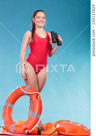 Lifeguard woman on duty with ring buoy lifebuoy. 134113824