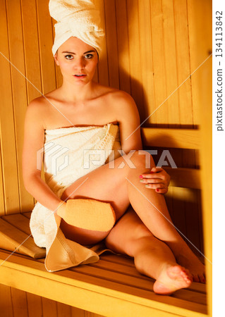 woman relaxing in wooden sauna room woman relaxing in wooden sauna room 134113842