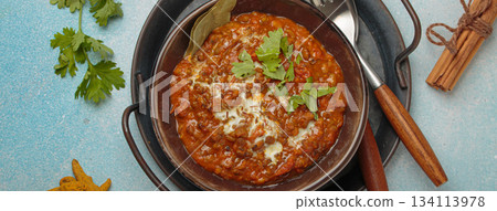 Dal makhani with cream and coriander in bowl is served with spices, traditional dish of India Dal makhani with cream and coriander in bowl is served with spices, traditional dish of India 134113978