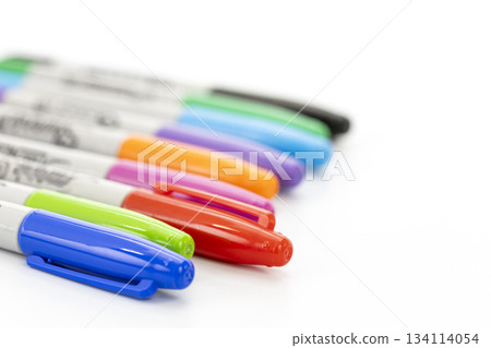 Close-up view of a set of colorful markers with caps on a clean white background showing various vibrant colors in a diagonal Close-up view of a set of colorful markers with caps on a clean white background showing various vibrant colors in a diagonal 134114054