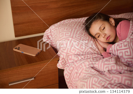 Headshot of a little child girl in pink pajama, sweetly sleeping in her bed Headshot of a little child girl in pink pajama, sweetly sleeping in her bed 134114379