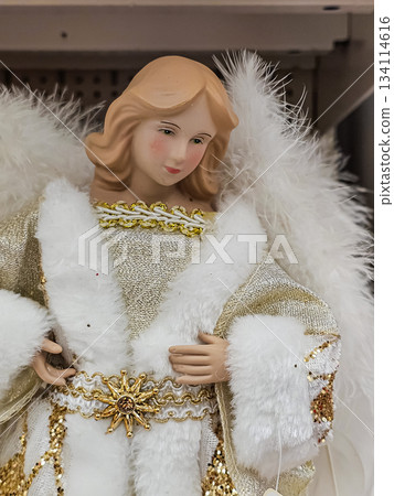 Close-up view of an angel figurine with delicate wings and white clothing. Elegant decorative ornament symbolizing peace, purity, and holiday spirit, suitable for Christmas and home decor themes. Close-up view of an angel figurine with delicate wings and white clothing. Elegant decorative ornament symbolizing peace, purity, and holiday spirit, suitable for Christmas and home decor themes. 134114616