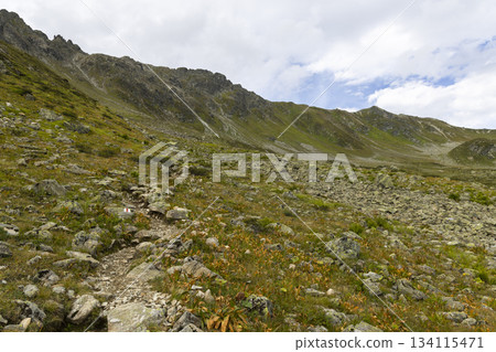 Hiking on Smugglerpfad trail in Gargellen, Montafon, Vorarlberg, Austria during cloudy weather 134115471
