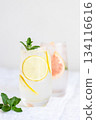 Glass of cold lemon water with mint garnish. 134116616