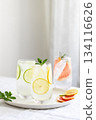Glasses with cold lime and lemon lemonade with mint garnish. 134116626