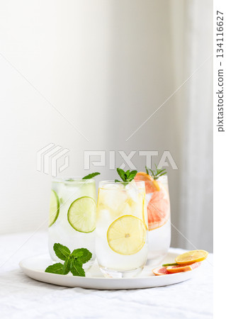 Glasses with cold lime and lemon lemonade with mint garnish. Glasses with cold lime and lemon lemonade with mint garnish. 134116627