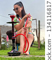 A girl outdoors with a hookah 134116817